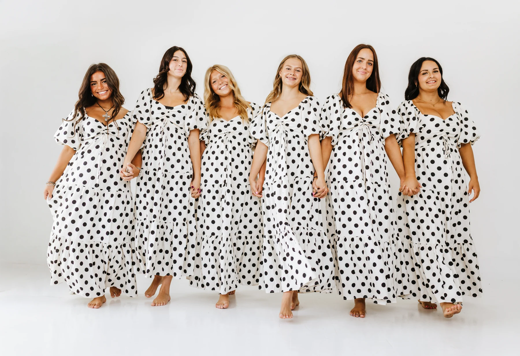 Friends wearing polka-dot maxi dresses from Courtney's Closet
